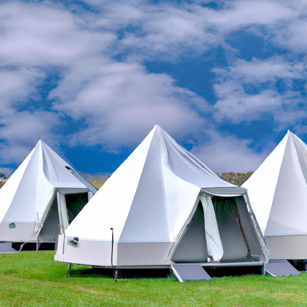 Several colorful tents pitched on grassy campground with surrounding trees and mountains. Campfire burning in center with chairs and picnic tables nearby. Clear sky with stars overhead, giving a peaceful and rustic outdoor experience.
